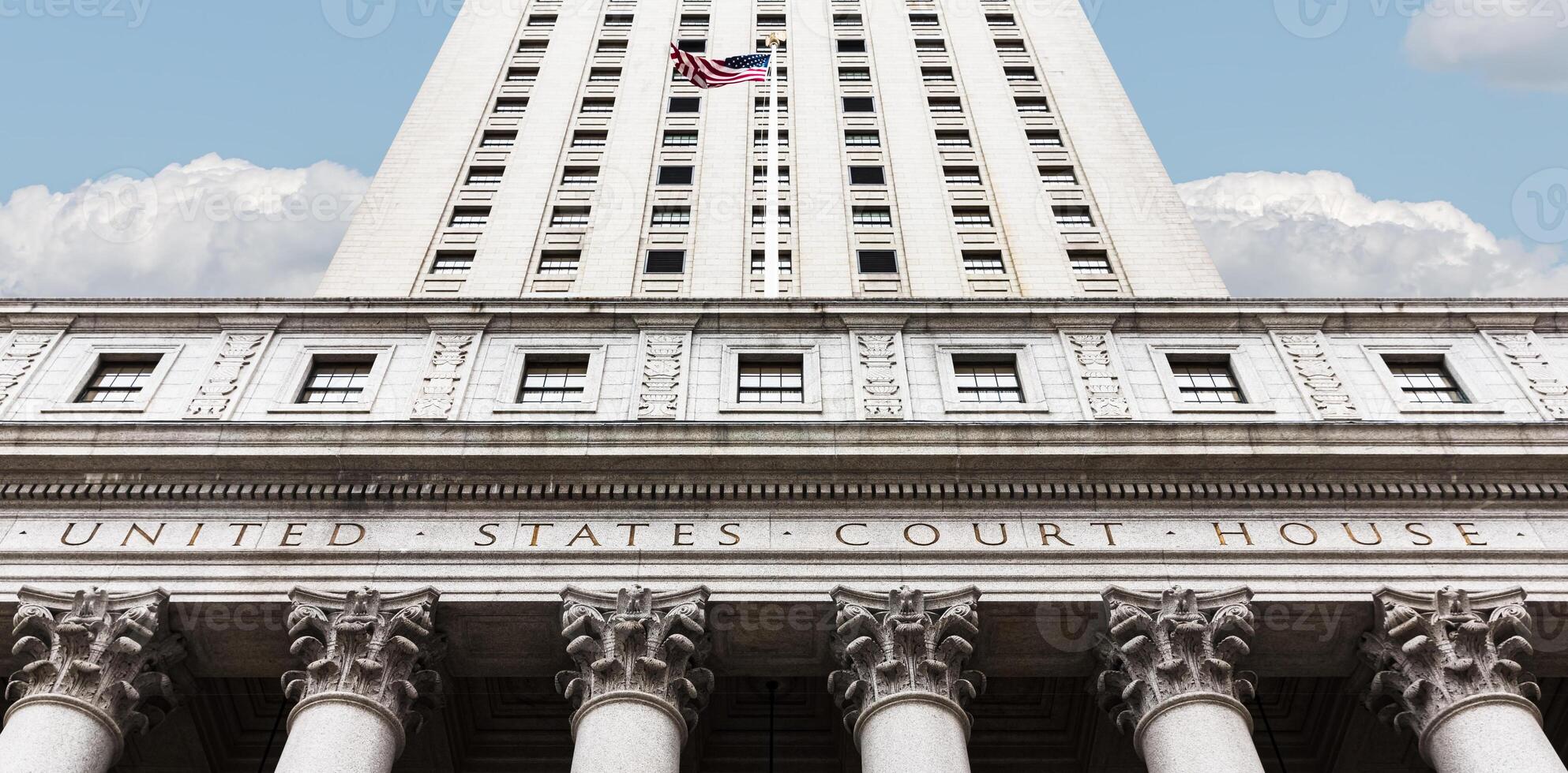 A building with columns and a flagpole photo