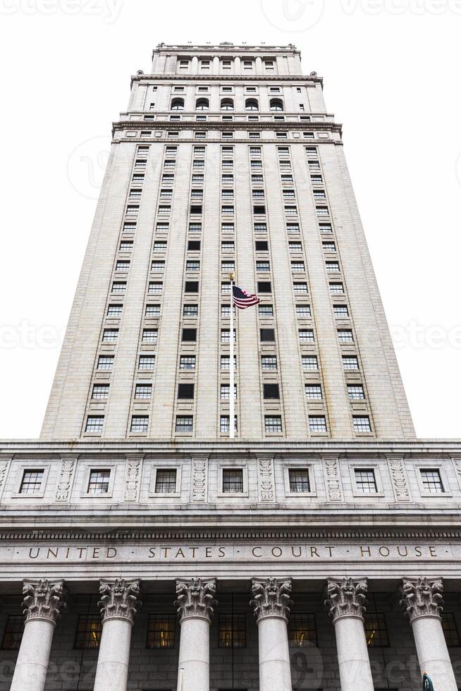 A tall building with columns and a flag pole photo