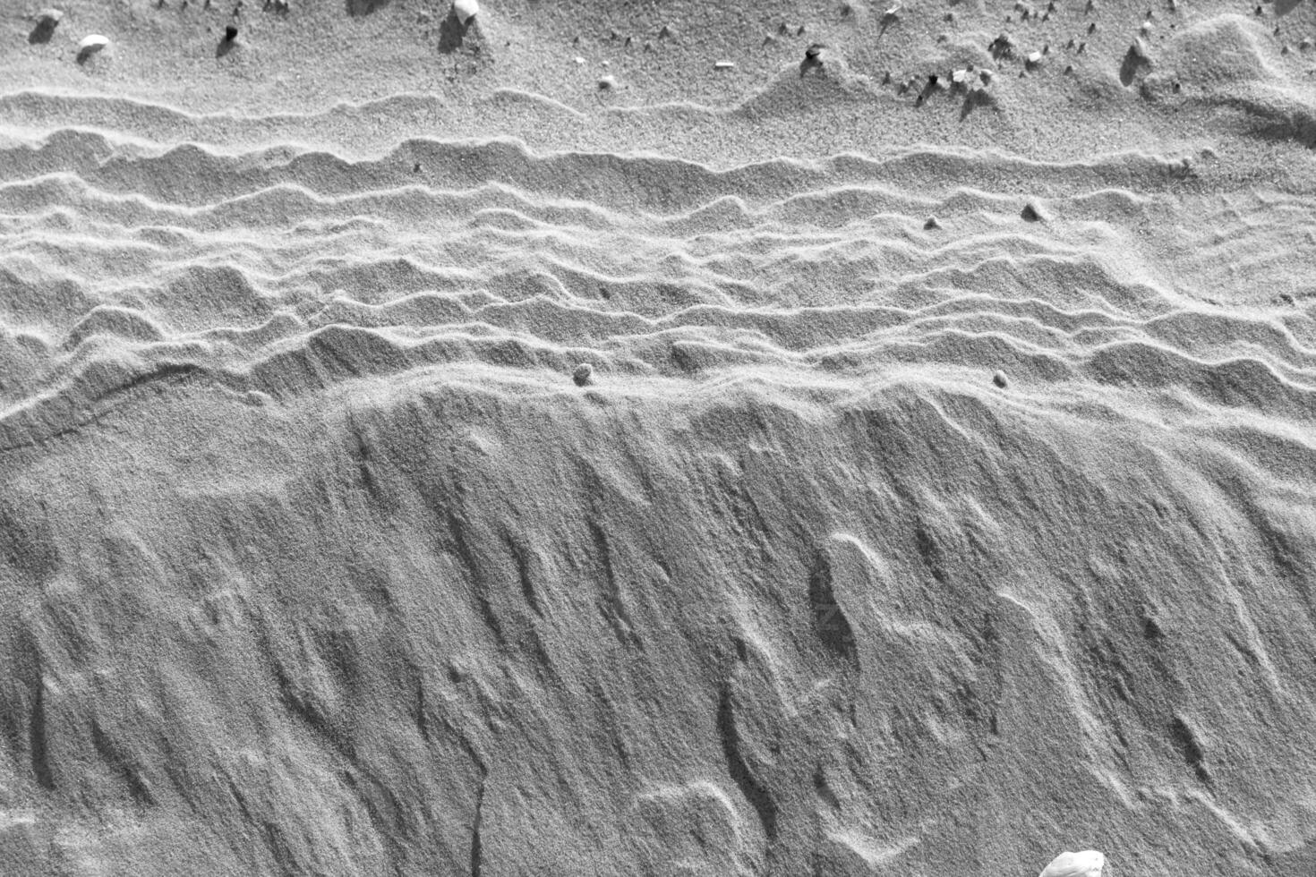 A black and white photo of a sand dune