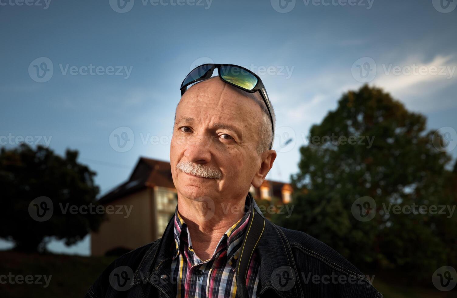 A man with a mustache and glasses photo