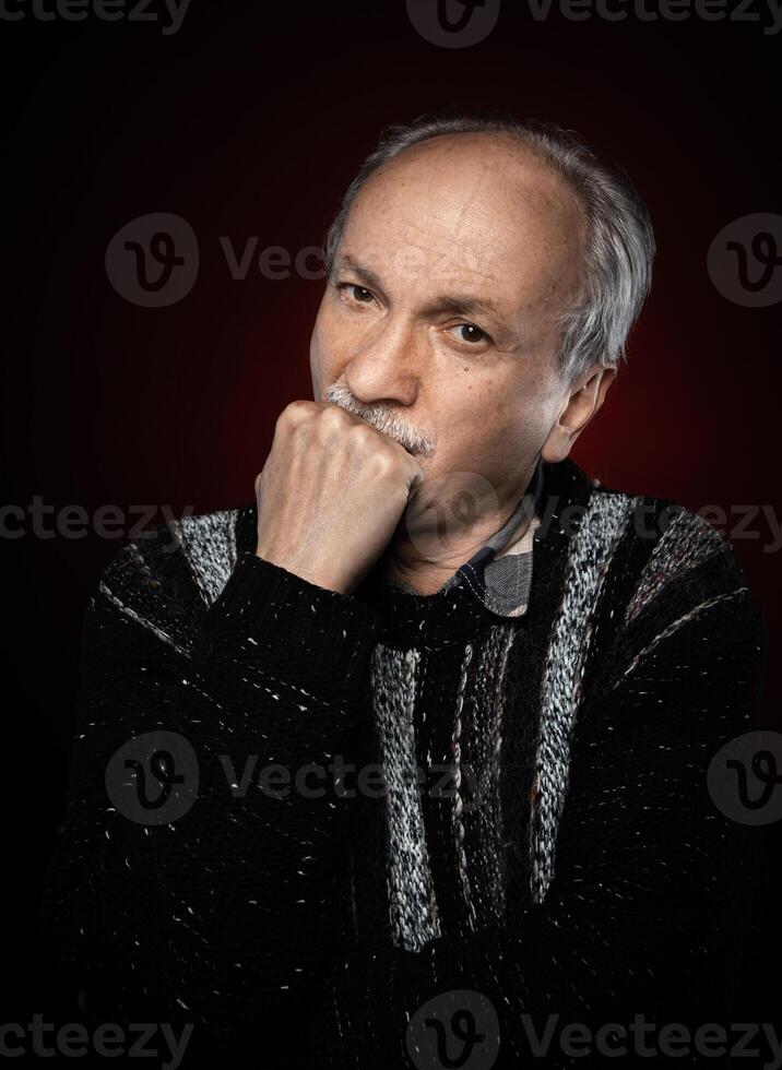 An older man with a beard and a black sweater photo