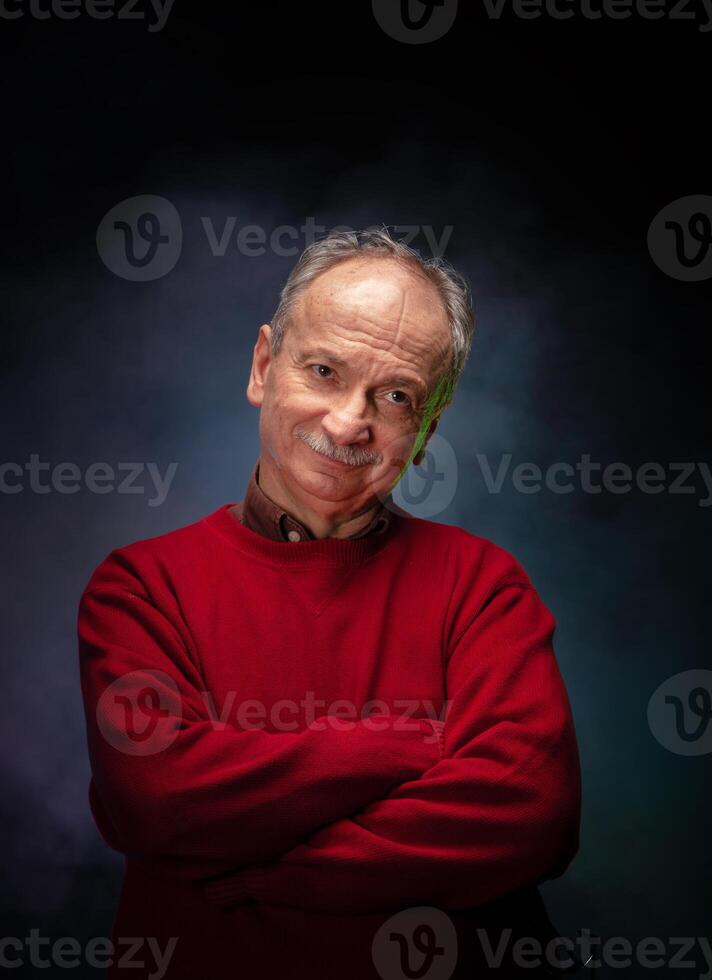 A man in a red sweater posing for the camera photo
