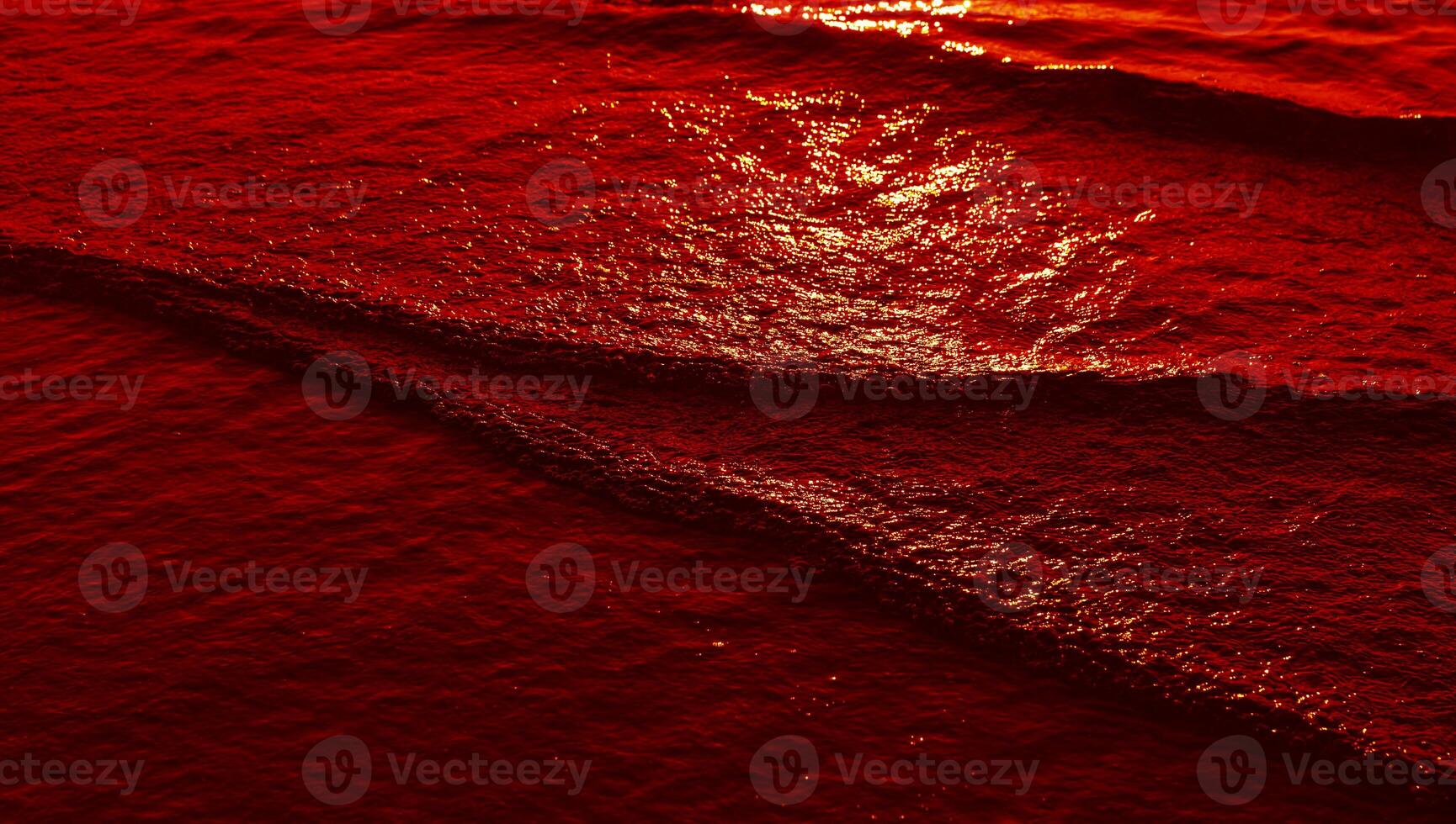 A red wave on the ocean surface photo