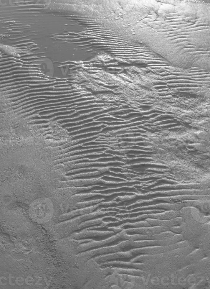 A black and white photo of a sand dune