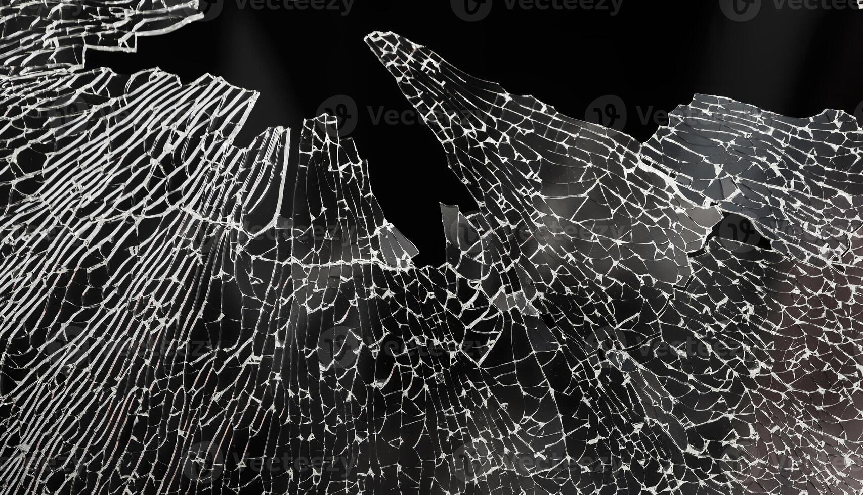 A broken glass window with a black background photo