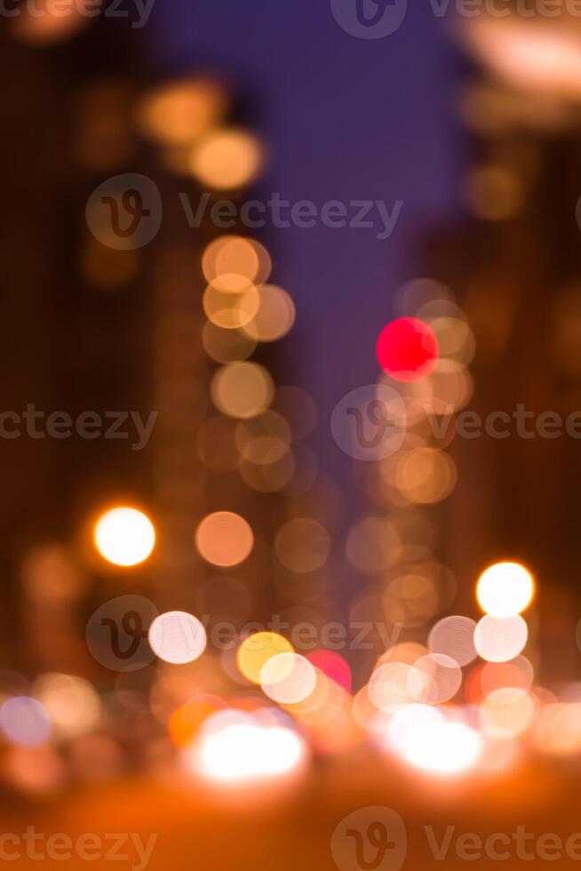 A blurry image of a city street at night photo