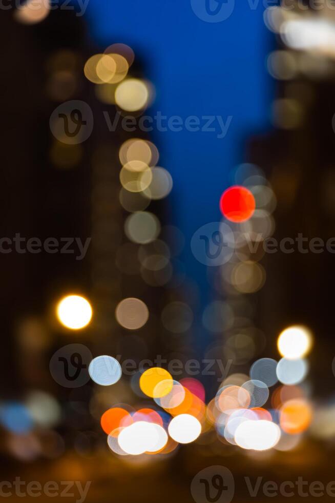 A blurry image of a city street at night photo