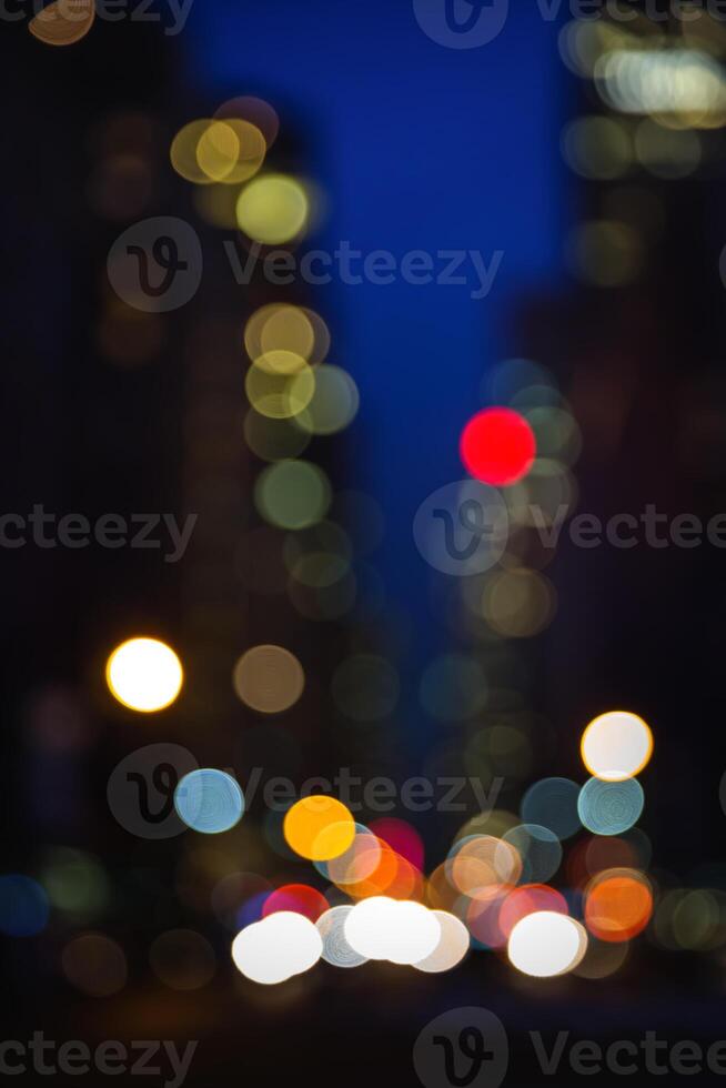 A blurry image of a city street at night photo