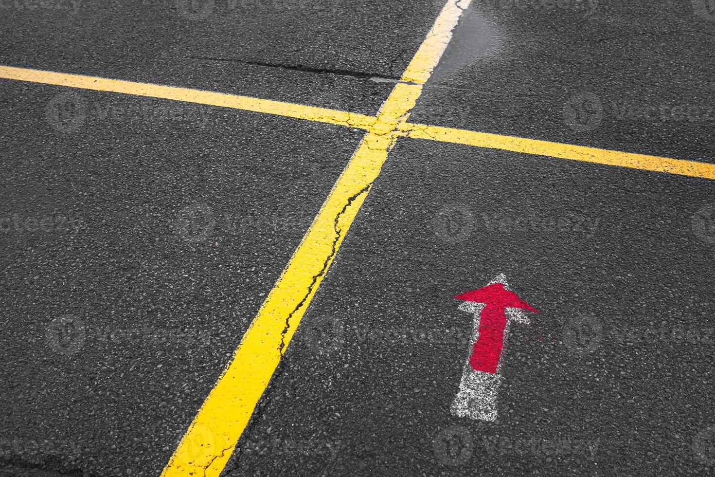 A red arrow pointing to the right on a road photo