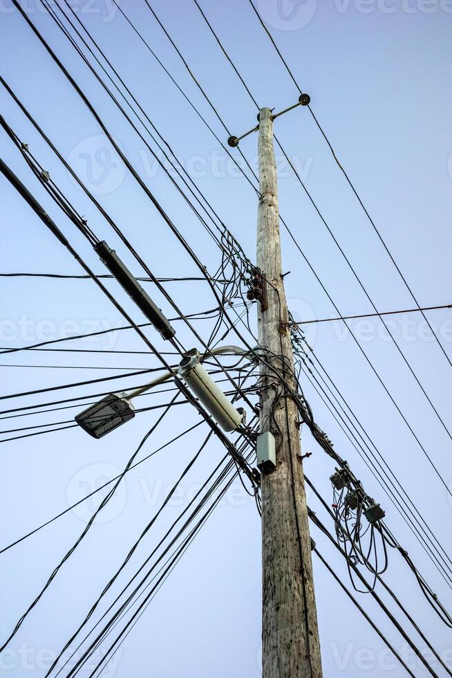 A telephone pole with many wires and wires photo