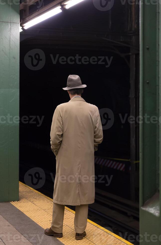 A man standing on a subway platform photo