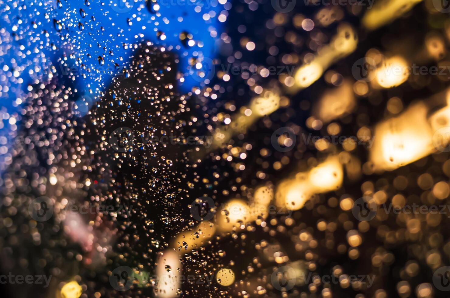 Raindrops on a window at night photo