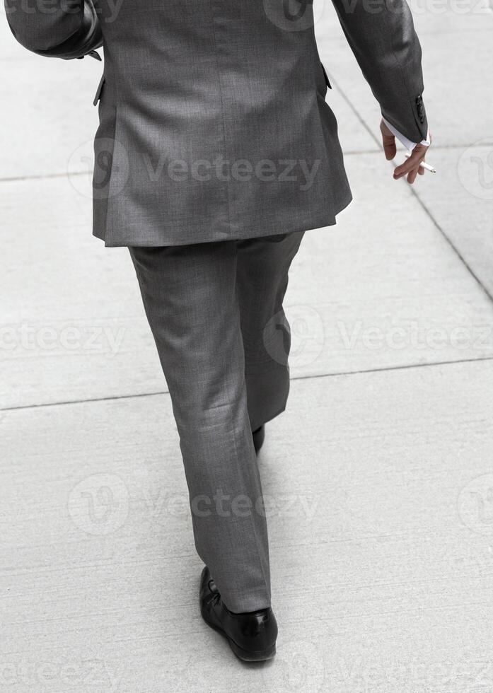 A man in a suit and tie walking down the street photo
