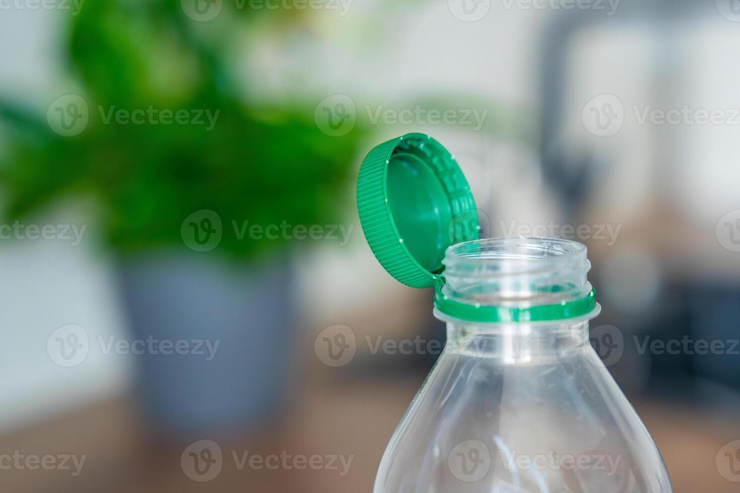 Stationary plastic cap on a PET bottle. The new design means the cap remains attached to the bottle after opening, making the entire package easier to collect and recycle. High quality photo