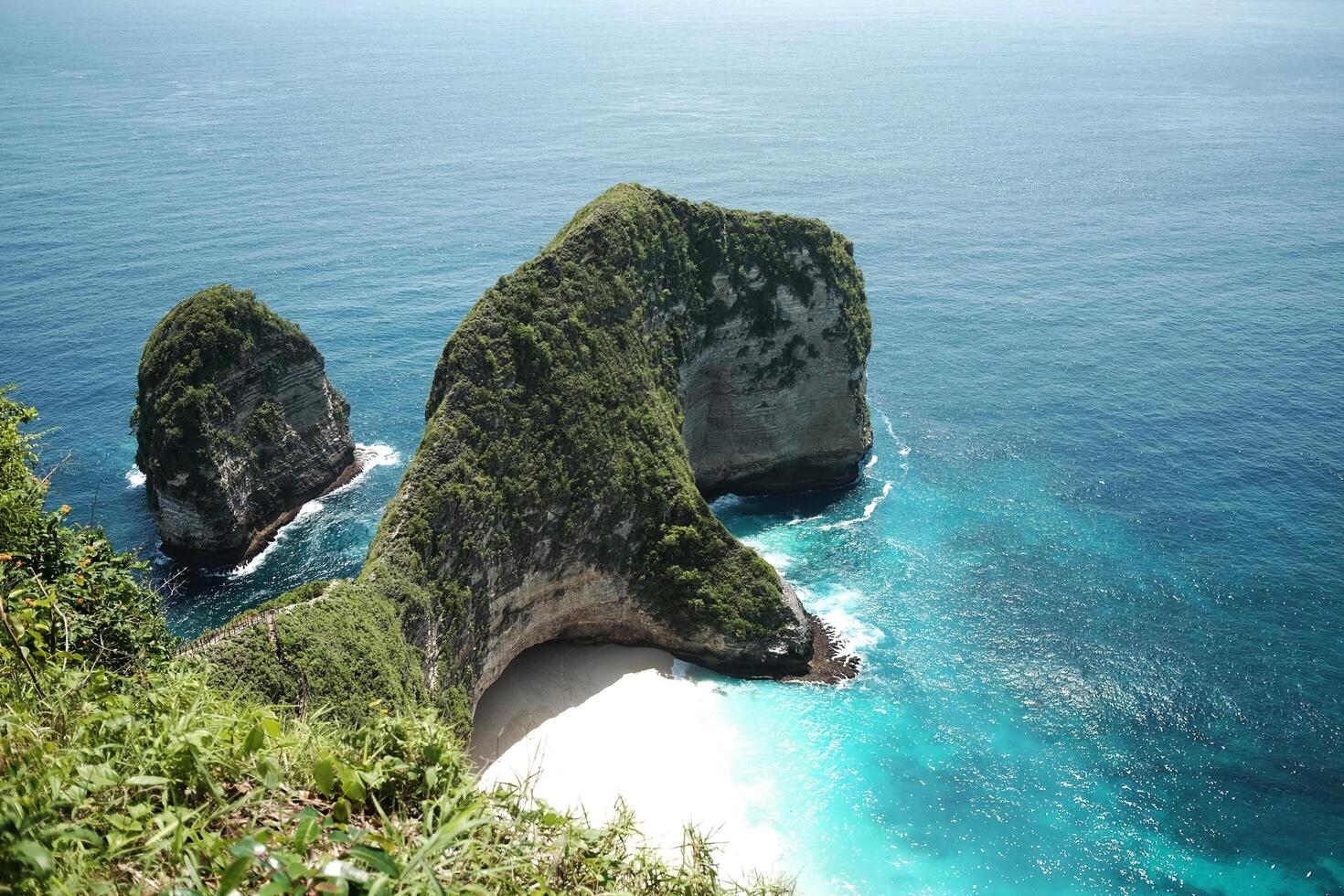Landscape of wave crashing rocky cliff and wild on stone mountain. Destination blue calm sea and ocean on summer at Kelingking beach is famous place in Bali island at Indonesia photo