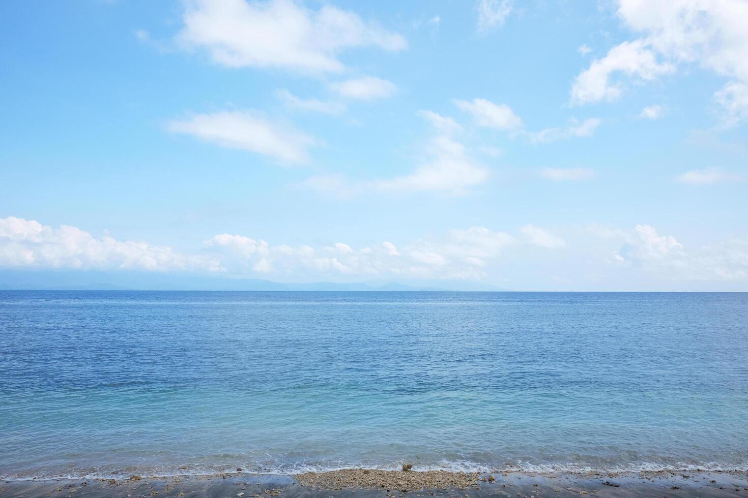 Landscape of horizon blue sea and beach destination travel summer ocean with cloud and sky in Bali island at Indonesia photo