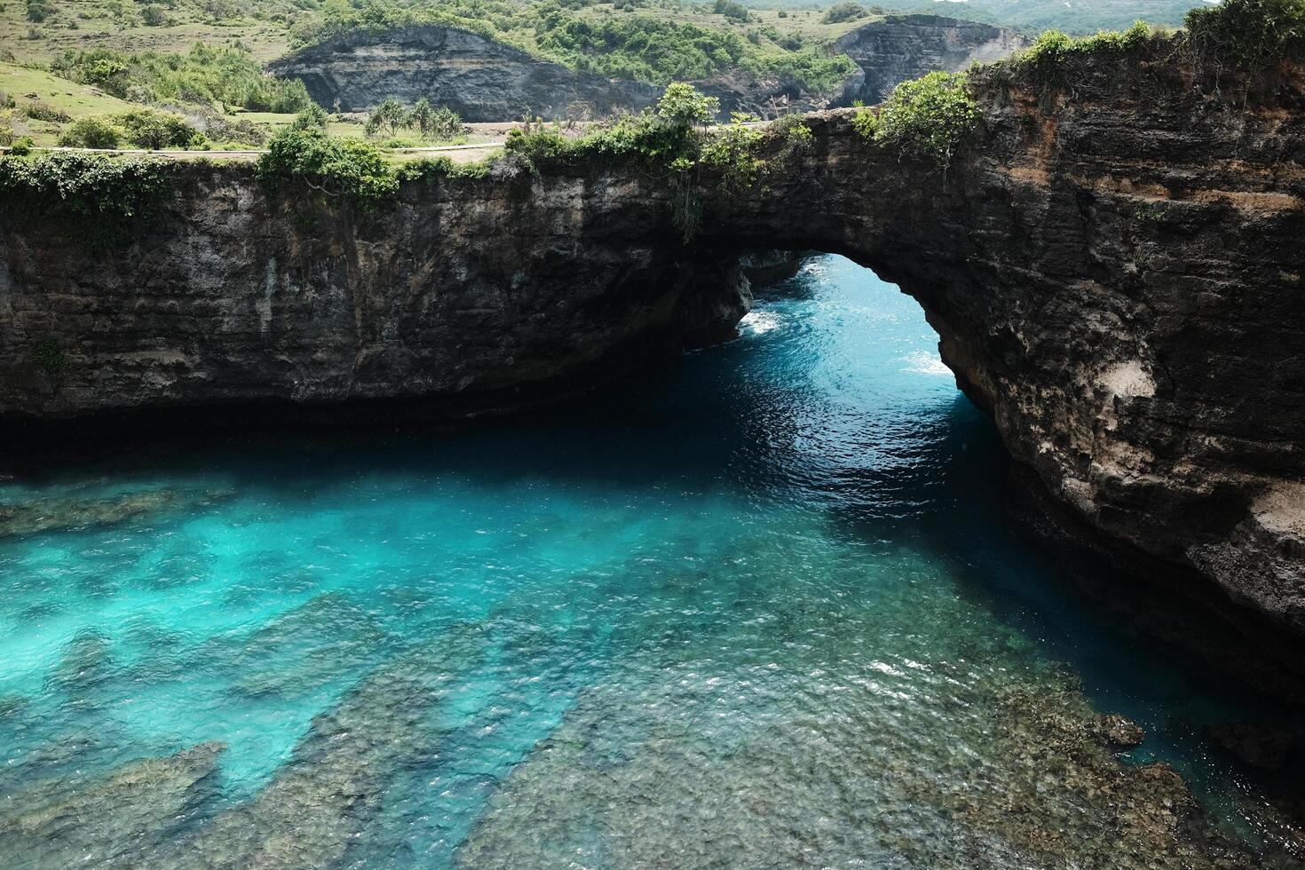 Landscape of wave crashing rocky cliff and wild on stone mountain at the blue calm sea and destination travel summer ocean on broken beach in Bali island at Indonesia photo