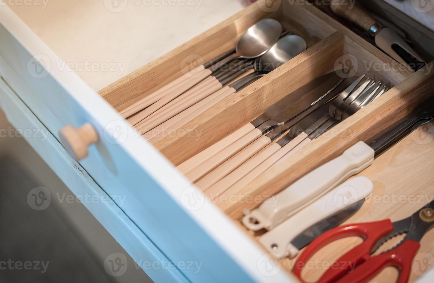 Open kitchen drawer with silverware , Kitchenware and dining accessories in drawer photo