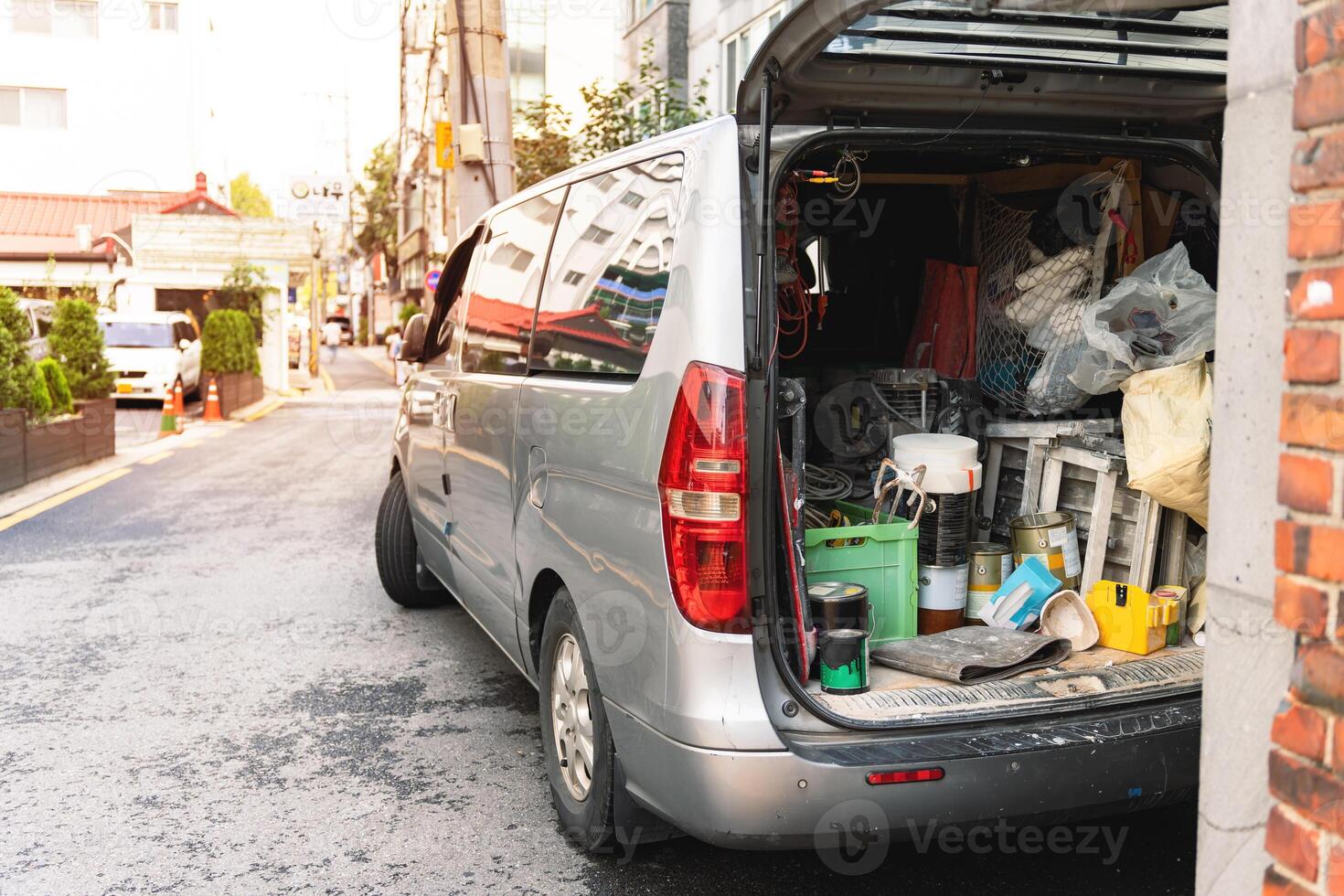 The inside of a van loaded with many tools, used by a home repair carpenter, Organise tools in the rear of vehicle concept photo