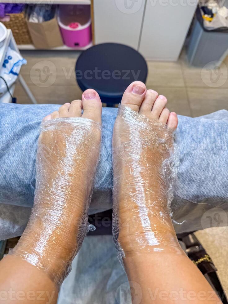 Feet wrapped in plastic during a foot spa treatment at a professional salon. High quality photo