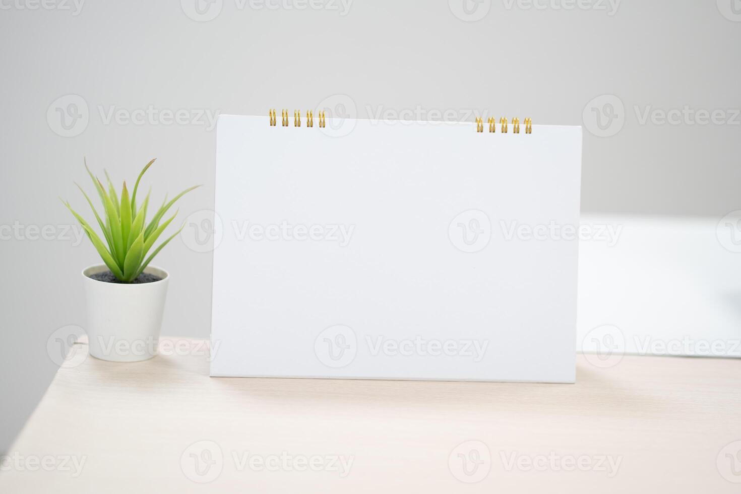 Blank desk calendar on table in mock up and copy space concept. photo