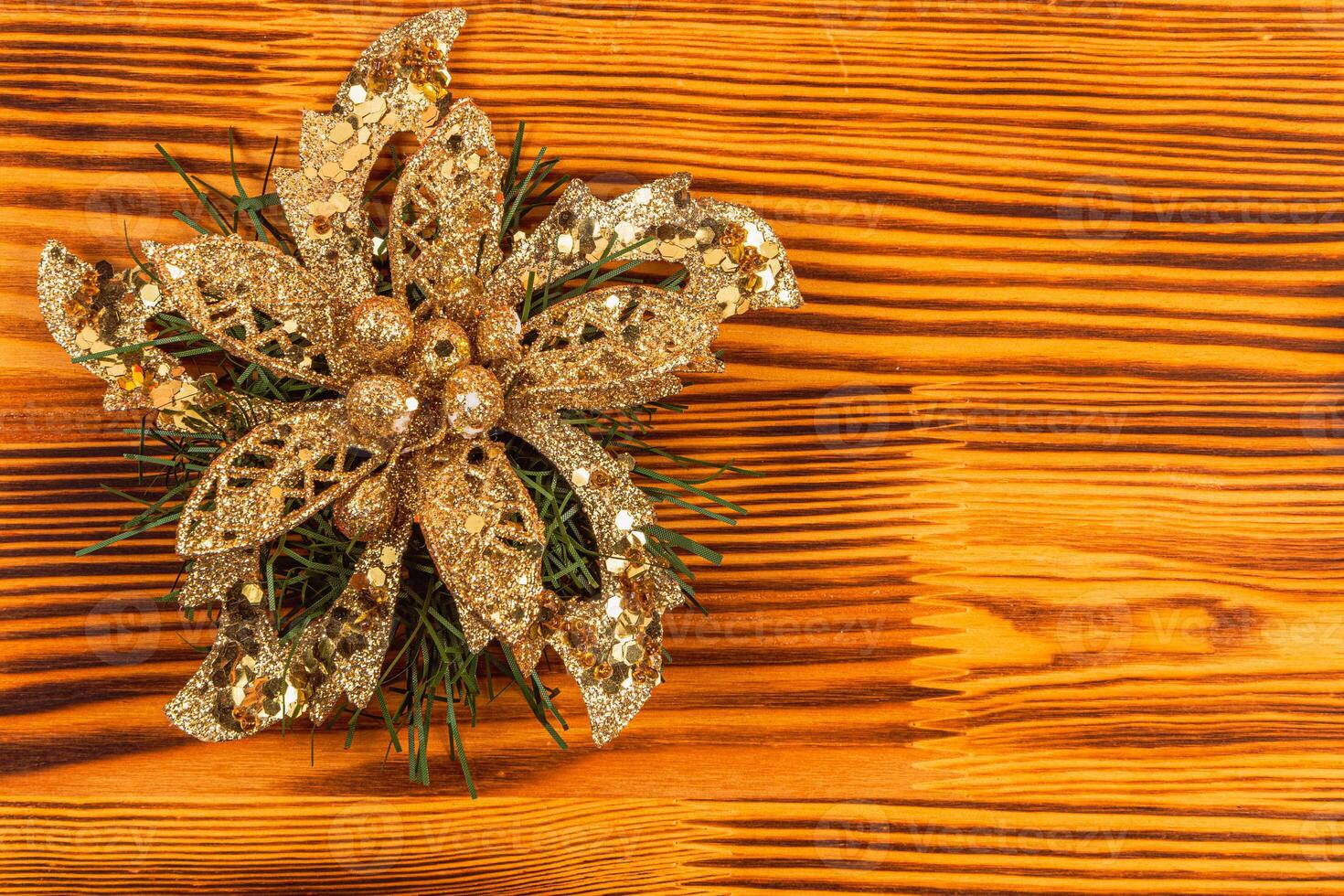 Christmas decoration golden flower on a beautiful wooden background photo