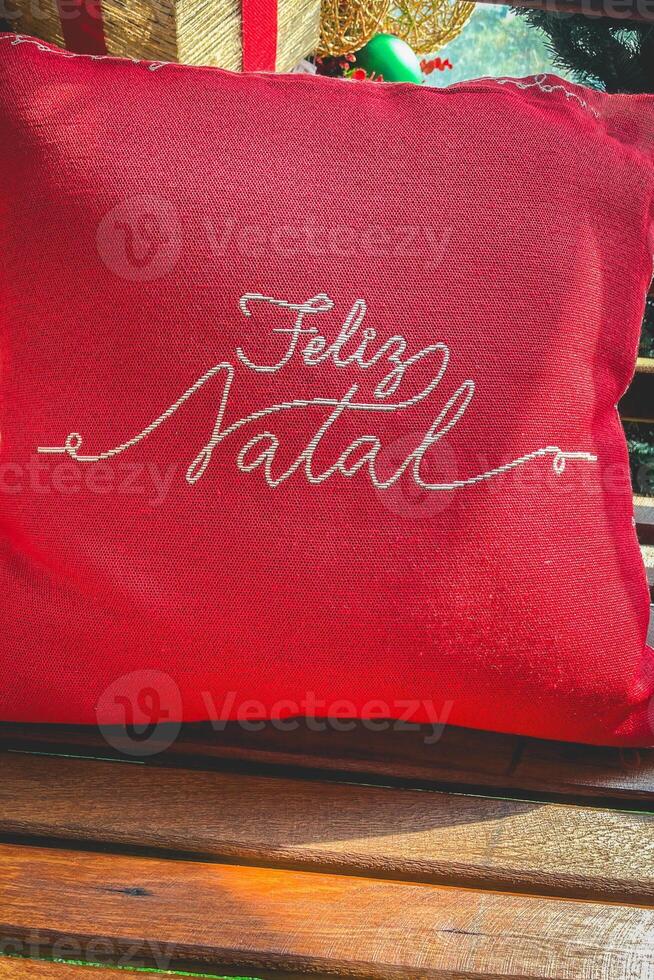 A red pillow with the text Feliz Natal on it. portuguese for Merry Christmas. photo