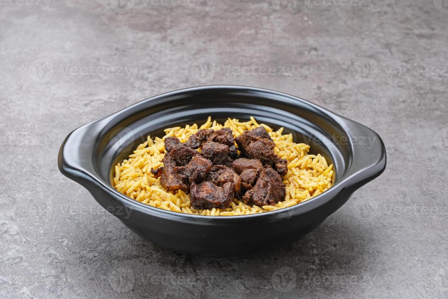 Nasi Kebuli Kambing, Arabian Rice with herb, spices and goat meat topping photo