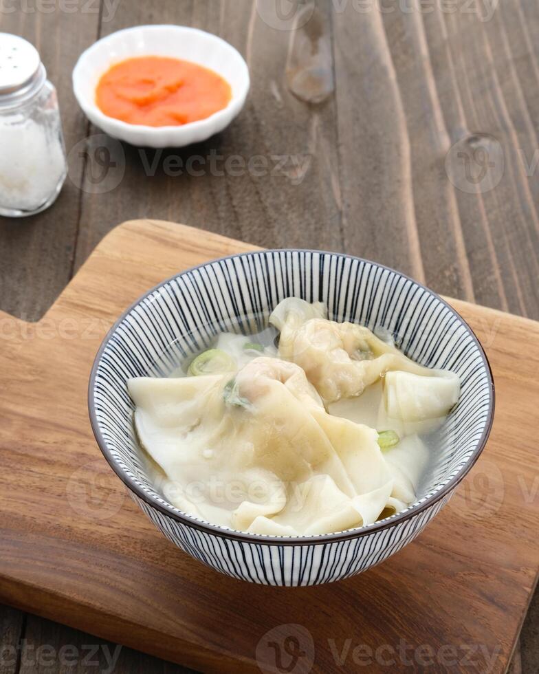 Yummy Wonton Soup or dumpling soup or Pangsit Kuah, served in bowl. photo