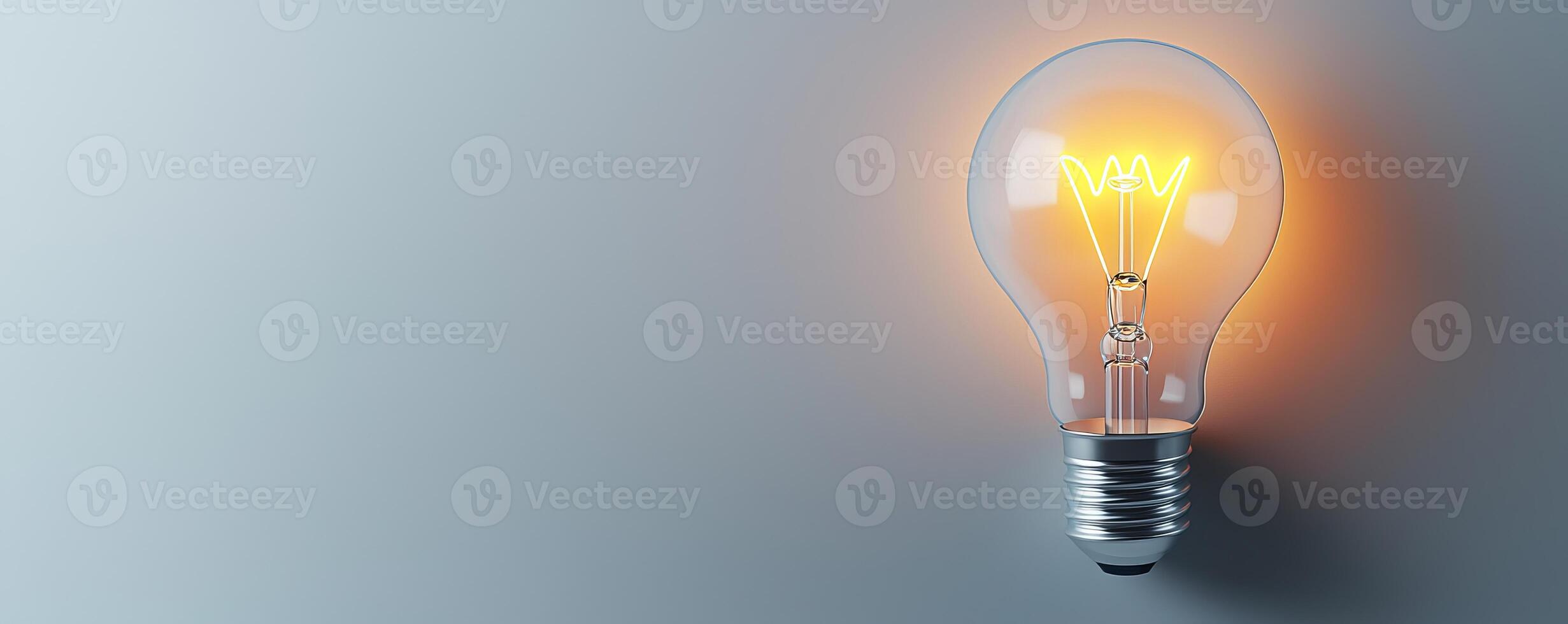 Bright light bulb glowing against a simple gray background, symbolizing ideas, innovation, and creativity. photo