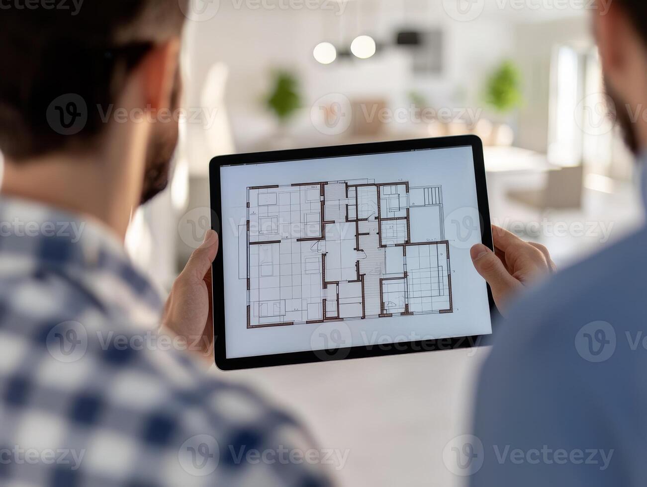 Two men discussing architectural plans on a tablet indoors. photo