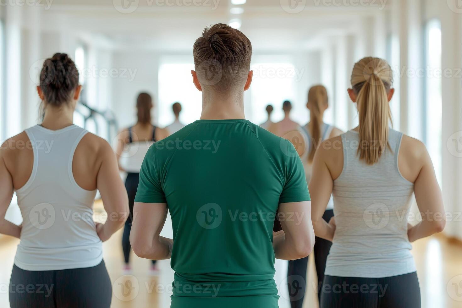 Group of people practicing yoga in a bright studio. photo