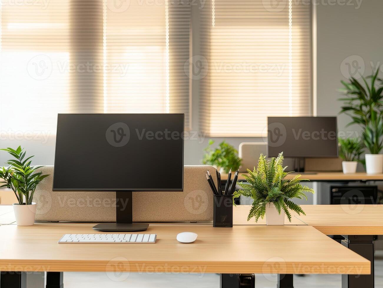 Modern office workspace with plants, computer, and natural light. photo