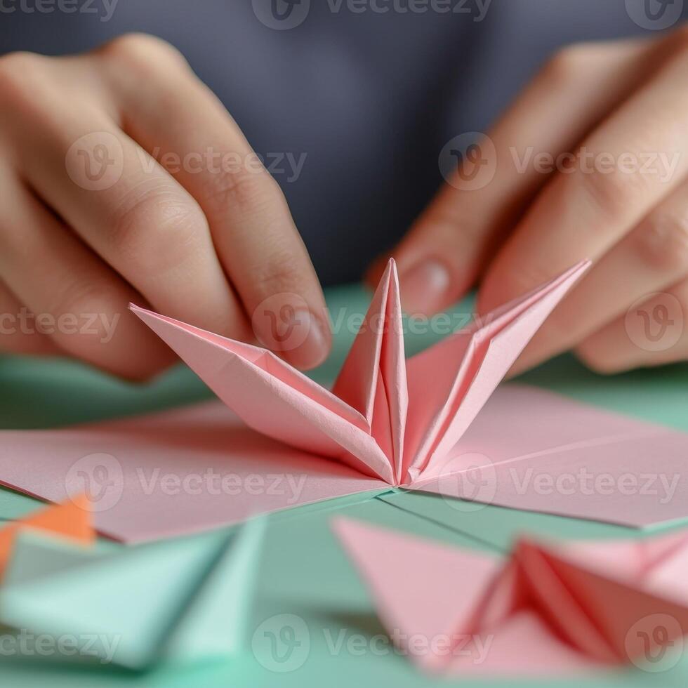 Hands crafting a colorful origami flower, soft focus, calming workspace. photo