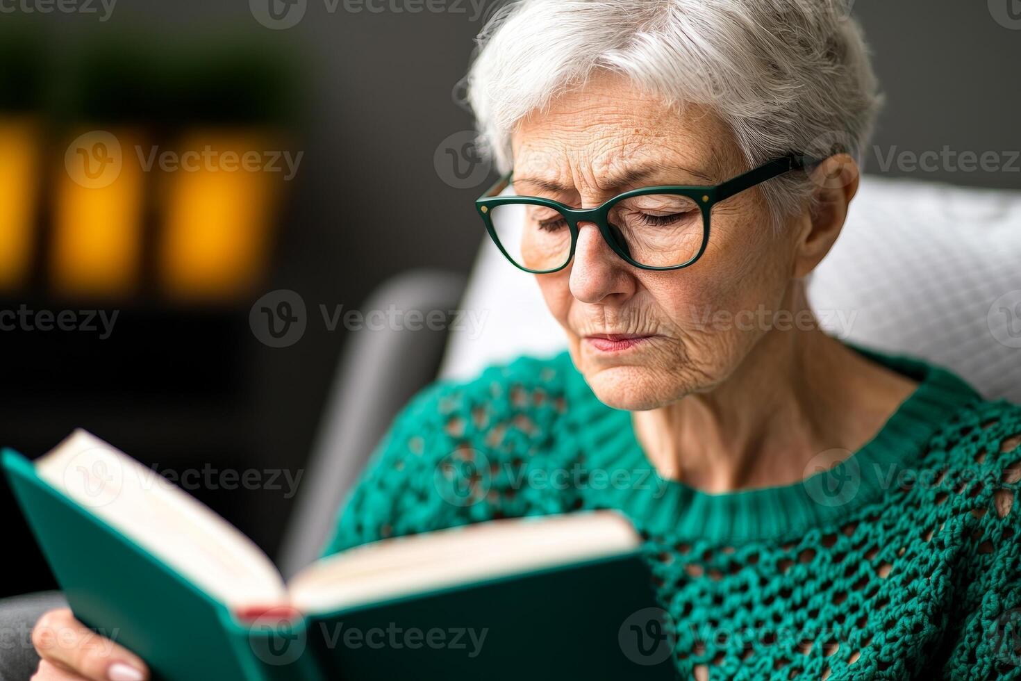 Elderly woman reading a book in a cozy living room setting. photo