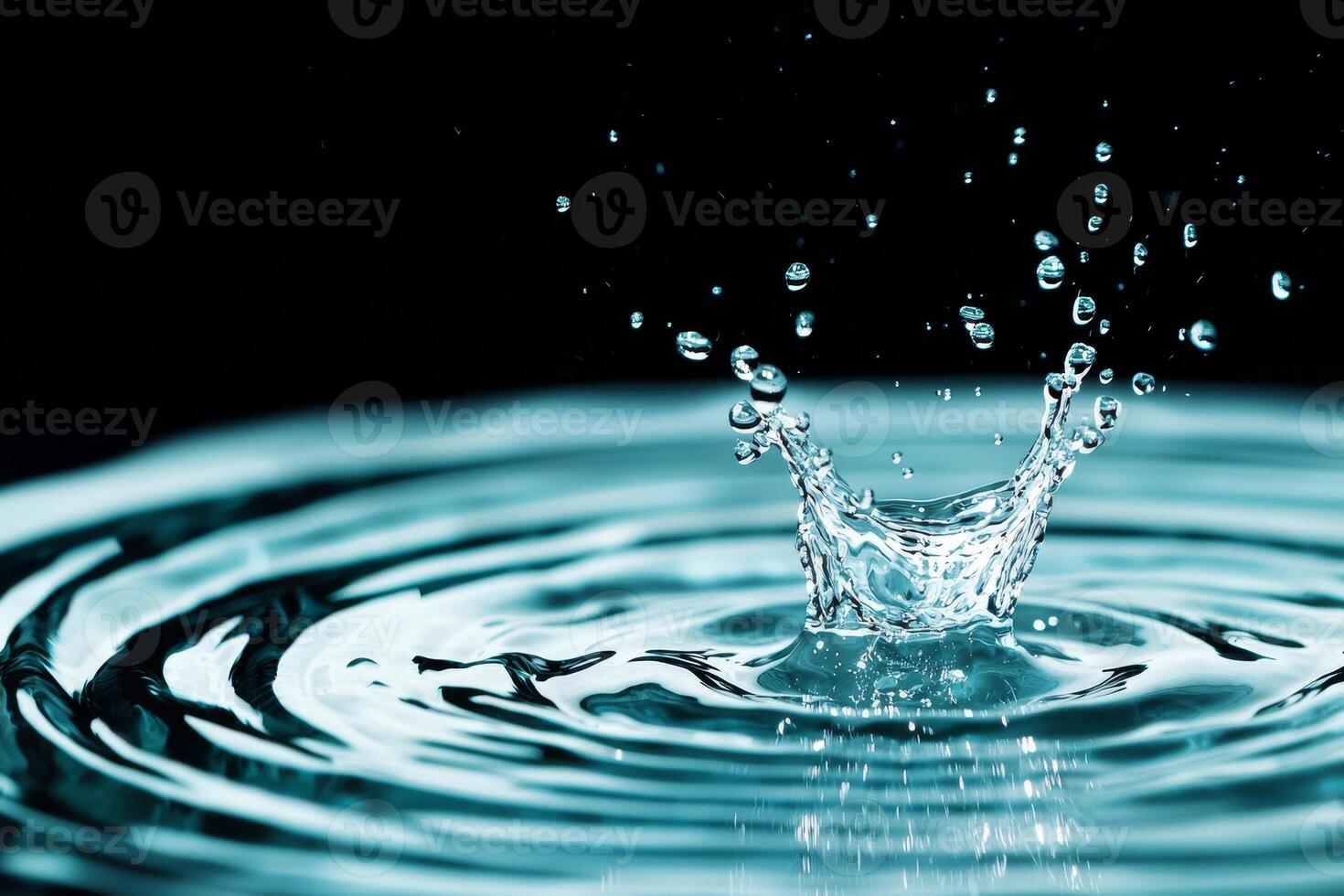 Water splash creating ripples, black isolate background. photo