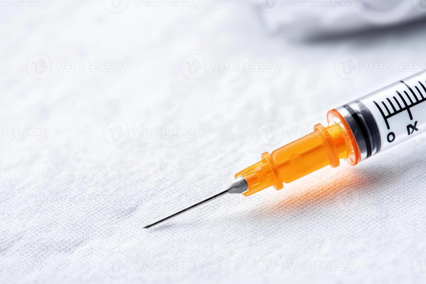 Close-up of a syringe on a white background, ideal for medical themes. photo