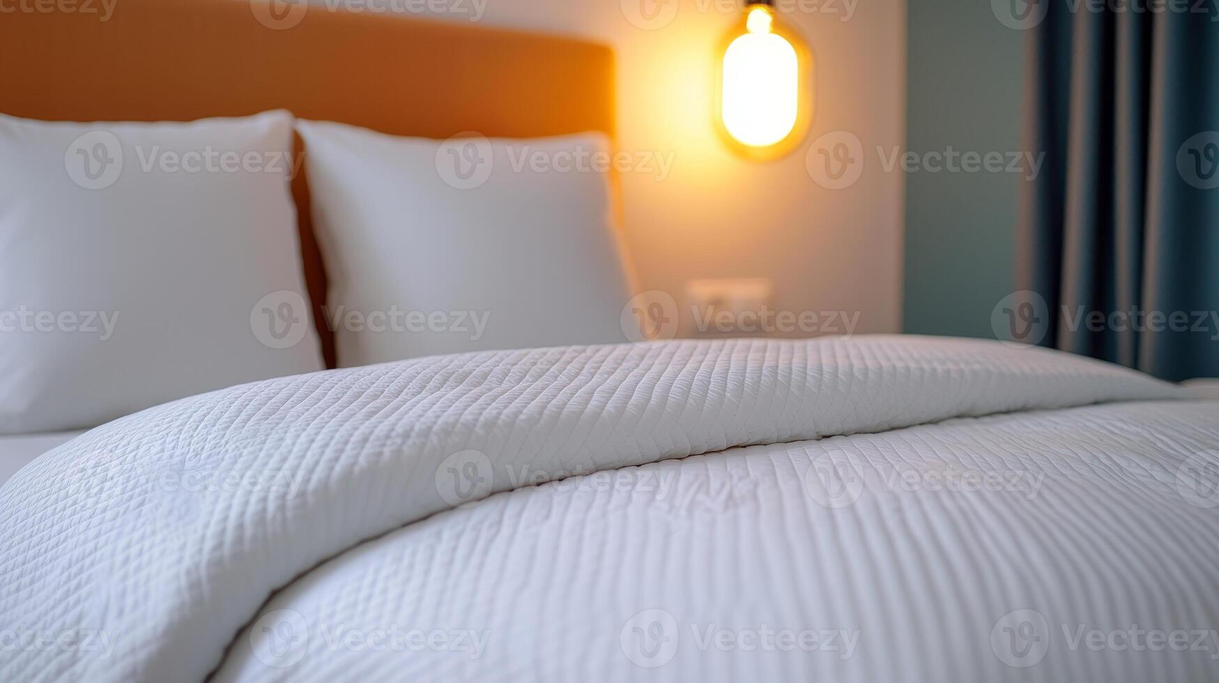 Cozy white bedding on a comfortable hotel bed with soft pillows. photo