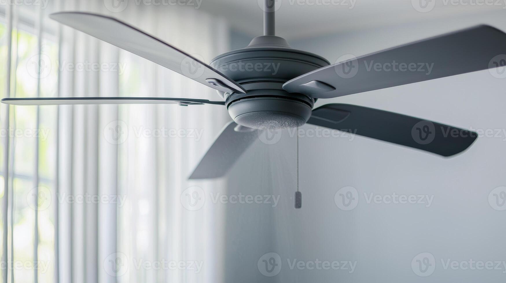 Modern ceiling fan with sleek blades in a contemporary room setting. photo