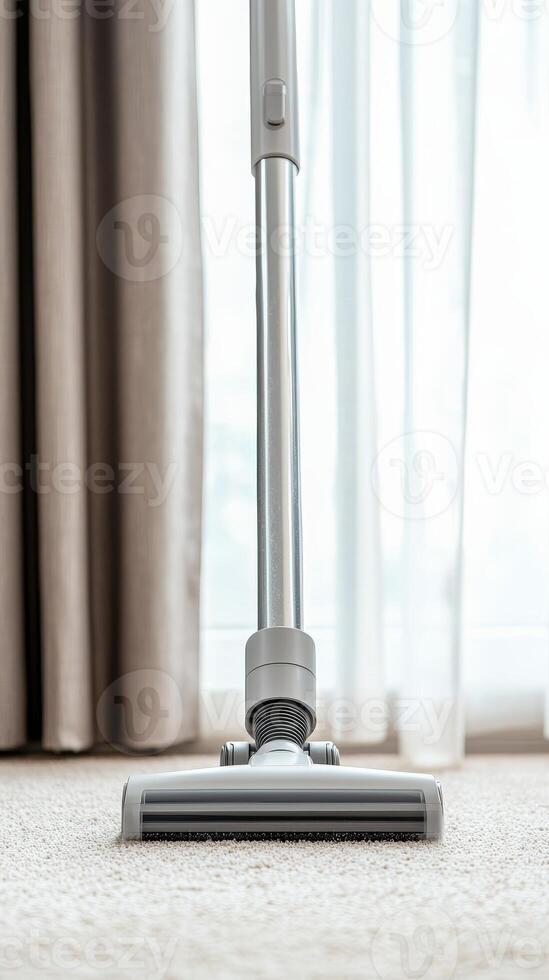 Vacuum cleaner head on carpet, bright natural light filtering through curtains. photo