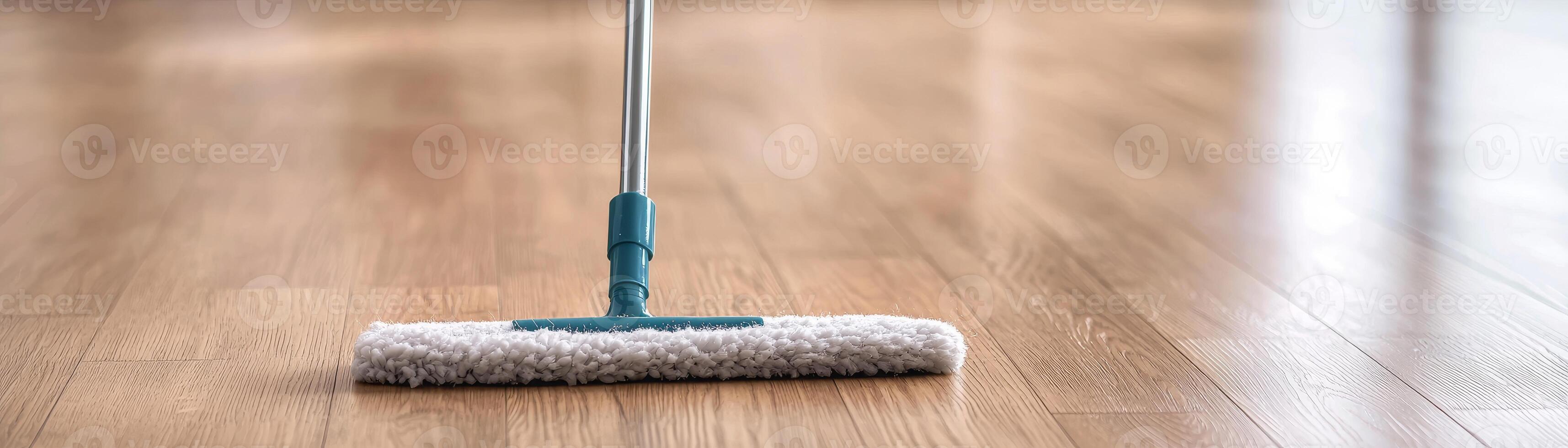 Cleaning tool on wooden floor, showcasing a tidy home environment. photo