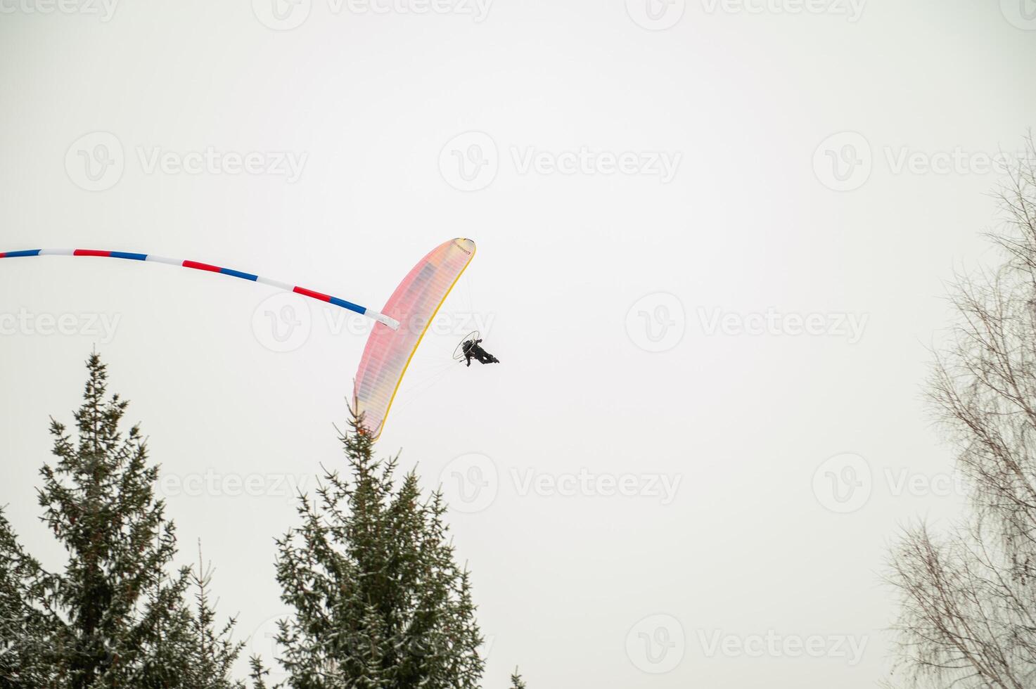 Paraglider is flying in the sky photo