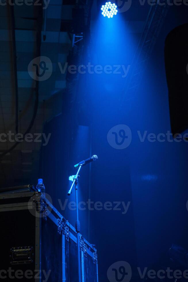 microphone in concert hall with blue lights photo