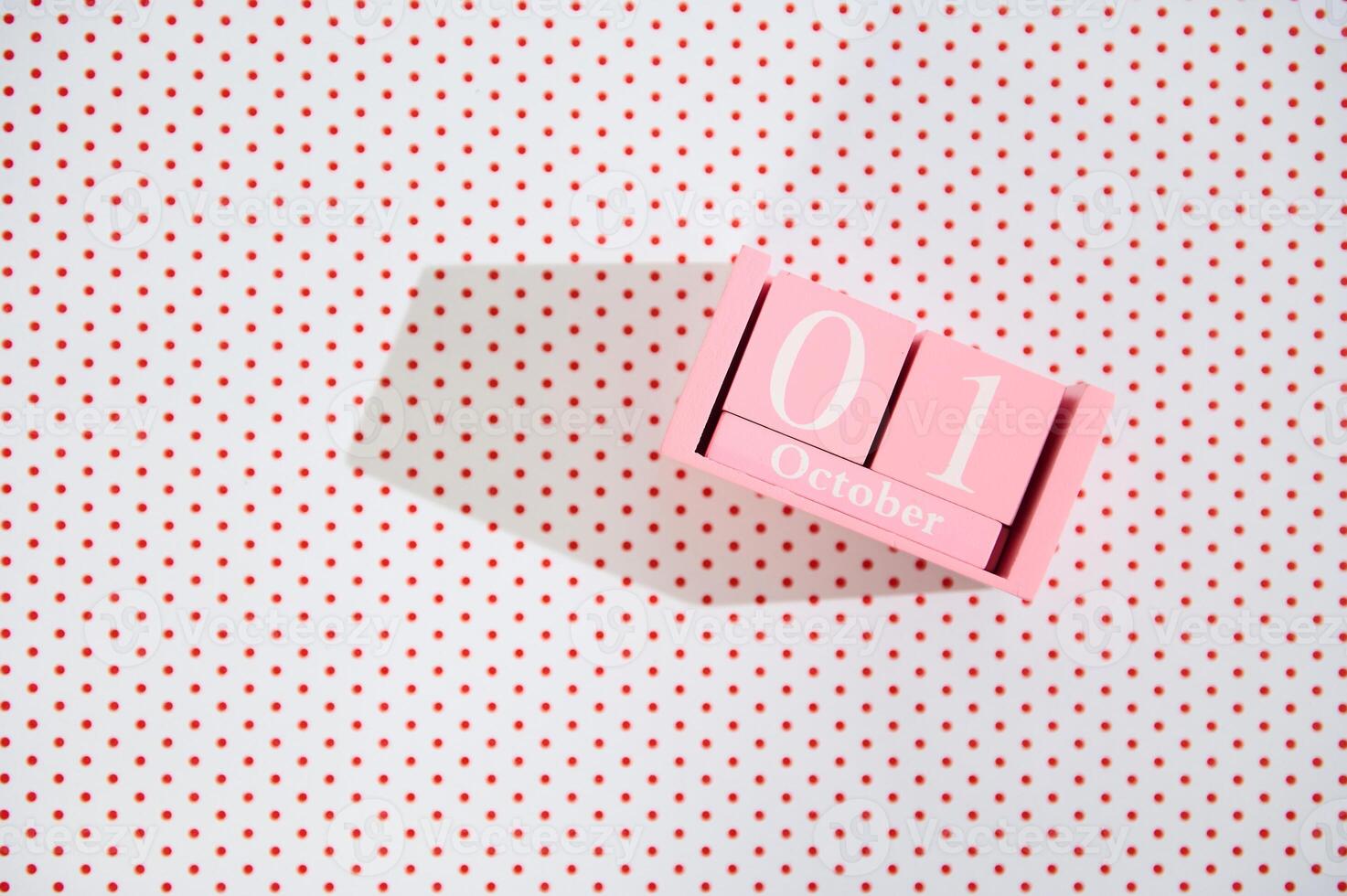 Pink Block Calendar on Polka Dot Background photo