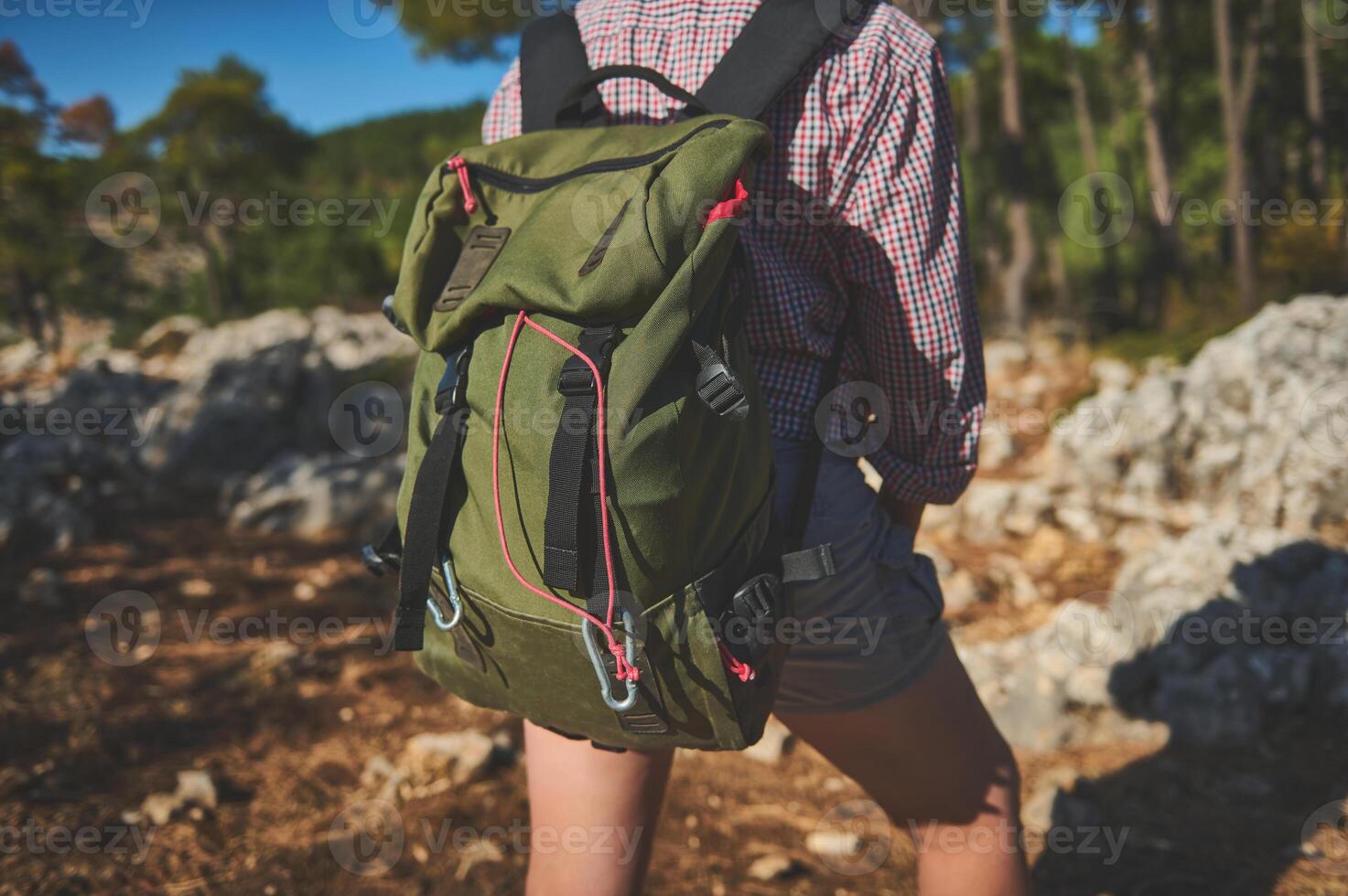 Hiking adventure with green backpack in a forest setting photo