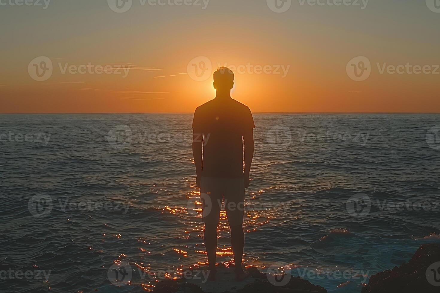 Serene Sunset Silhouette Person Contemplating Ocean Horizon for Peaceful Reflection photo
