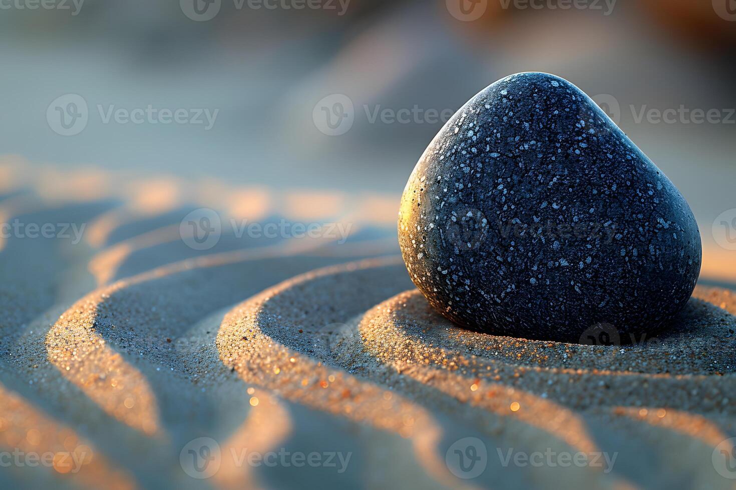 Tranquil Beach Scene with Smooth Stone on Rippled Sand at Sunset photo