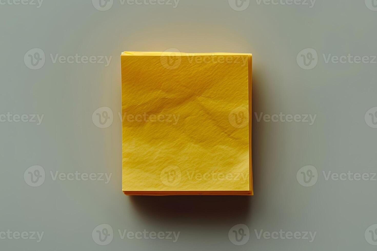 Bright Yellow Sticky Note Pad on Neutral Background for Office Creativity and Organization photo