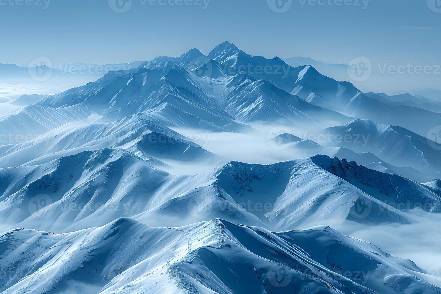 Majestic Snow-Covered Mountain Range with Misty Valleys photo