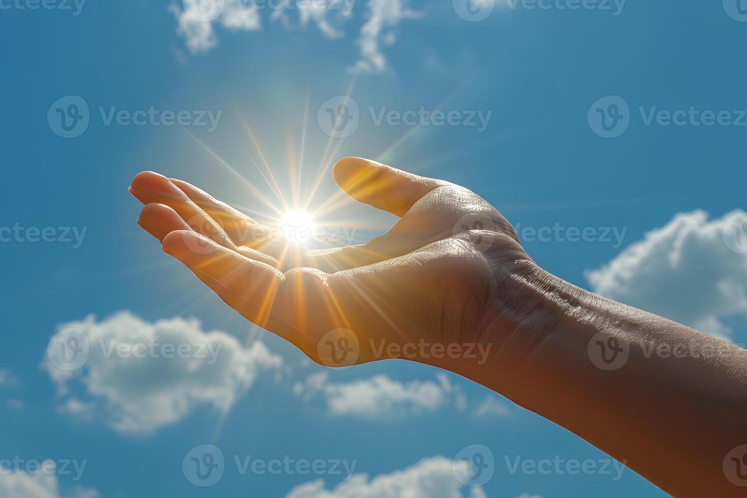 Hand Embracing Sunlight Against Blue Sky for Inspiration and Hope Concepts in Digital Design photo